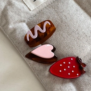 Set of three cute hair clips with strawberry, heart, and tortoiseshell patterns