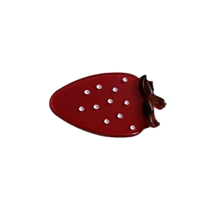 Cute strawberry shaped red resin hair clip with white dots and amber leaves on white background