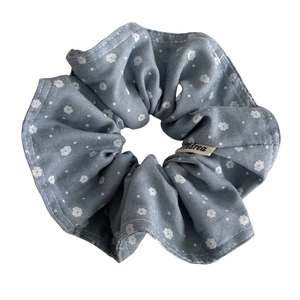 Blue floral scrunchie with white dots and brand tag on a clean white background