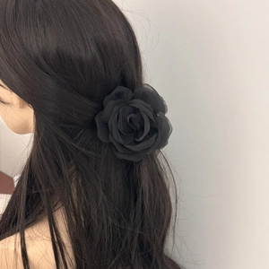 Elegant black tulle rose hair claw clip shown on a long straight hairstyle model