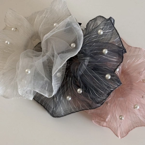 Detail of tulle scrunchies with silver stripes and pearls in white, black and pink
