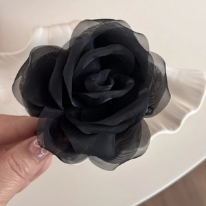 Detail of the layered black mesh rose hair claw clip showcasing 3D floral texture