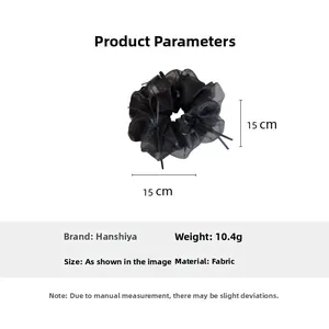 Detail view of 15cm oversized black organza scrunchie with lightweight mesh texture