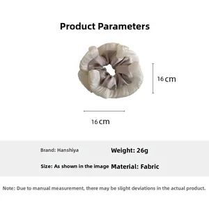 Detail view of a 16cm large pleated scrunchie made of white and gray satin fabric