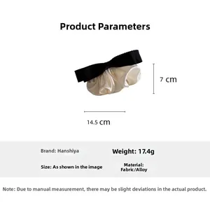 Detailed size and weight view of black and white bow hair clip with ruffle fabric