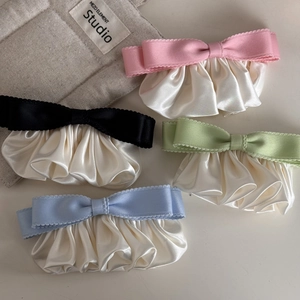 Detailed view of ruffle ribbon bow hair clips in pink, black, green, and blue colors