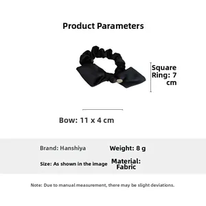 Detailed view of black satin bow hair tie with metal plate and specific size measurements