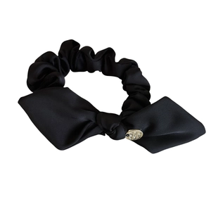 Elegant black satin bow scrunchie with golden metal charm engraved with Made With Love