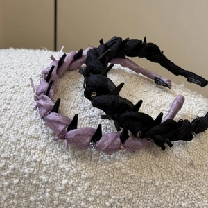 Detailed close-up of handmade bow headbands with rhinestones and punk style spikes
