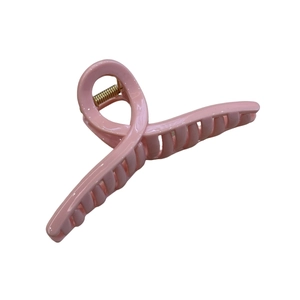 Minimalist light pink hair claw clip with cross design and gold metal spring on white background