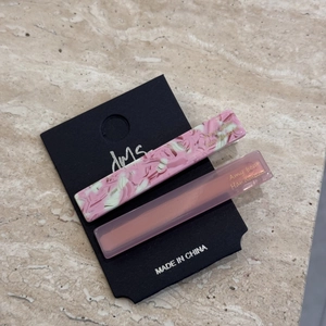 Close-up of pink marble and frosted hair clips on a professional display card