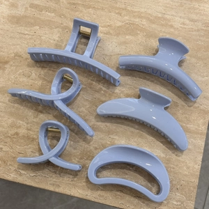 Set of six light blue matte hair claws in various shapes for women's hair styling