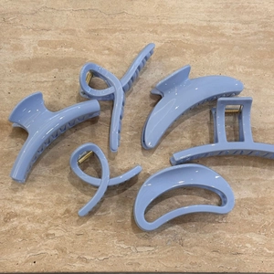 Set of six light blue minimalist hair claws in various elegant shapes for women