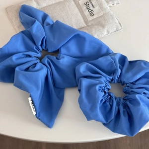 Royal blue scrunchie set with bow ribbon and classic fabric texture on white background