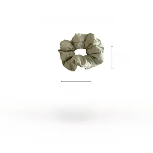 Detail showing oversized green satin scrunchie with pink polka dots and 15cm diameter size
