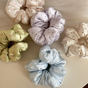 Five polka dot satin scrunchies in pastel colors for gentle hair styling and ponytails