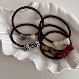 5-piece elastic hair tie set with acetate bow accents in leopard and marble patterns
