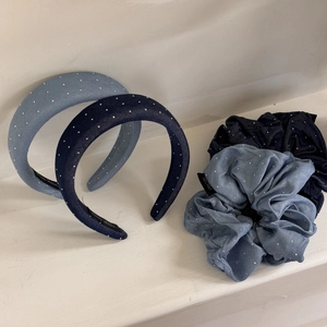 Detail of handmade denim blue hair accessories with white starry glitter texture