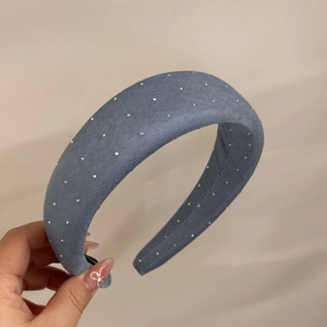 Detail of blue denim headband featuring sparkling rhinestones and thick sponge design