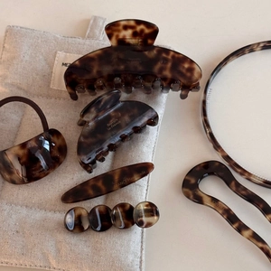 Flat lay of tortoiseshell acetate hair accessory set with clips and headbands