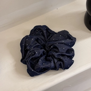 Detail of dark blue denim hair scrunchie with sparkling rhinestones and retro texture
