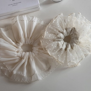 Elegant ivory lace and satin scrunchies with pleated ruffles on white background