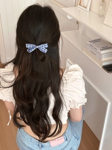 Close-up of a blue checkered bow hair clip styled in a minimalist Korean half-up hairstyle