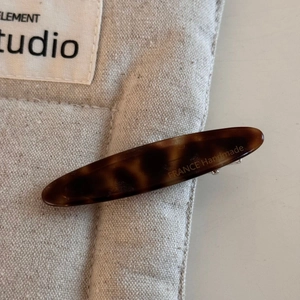 Detail view of handmade tortoiseshell hair claw clip with France handmade engraving