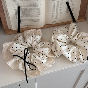 Creamy white heart print scrunchies with lace edges and ribbon bows in a retro style