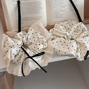 Detail of cream oversized scrunchie set with heart print and delicate lace edges