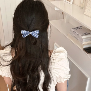 Korean style blue plaid bow hair clip shown on dark curly hair for a retro minimalist look