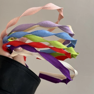 Elegant twisted fabric headband in multiple colors for a stylish daily hair accessory look