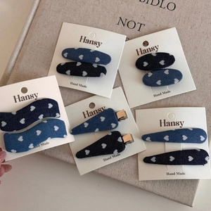 Detailed set of denim hair clips with white heart patterns on display cards