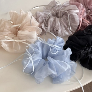 Detail of multi-color organza scrunchies with elegant ribbon bows for hair styling