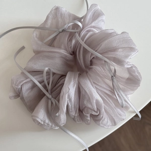 Detail of lavender oversized organza scrunchie with delicate ribbon bows and pearly sheen