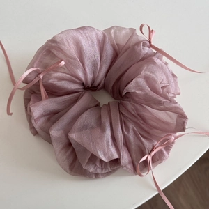 Detailed texture of light purple organza scrunchie with delicate ribbon bows