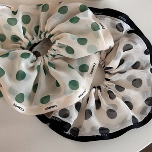 Elegant chiffon polka dot scrunchie with CHANGE lettering ribbon for stylish ponytails