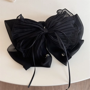 Détails de la grande pince à cheveux noire avec nœud en mousseline plissée et perles fines