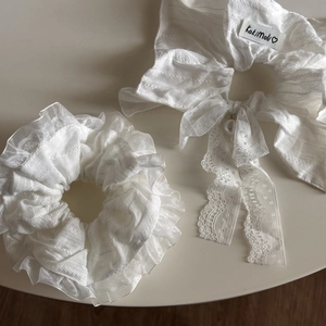 White lace hair scrunchies set with ribbon bow and pearl detail for elegant hairstyles