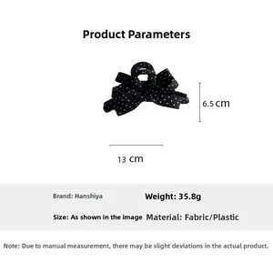 Detail view of large 13cm black and white polka dot bow hair claw clip with measurements