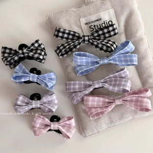 Set of four plaid bow hair clips in black, blue, purple, and pink for elegant hair styling