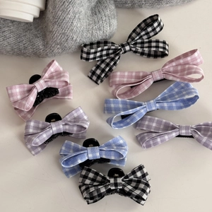 Detail of sweet gingham bow hair clips set showing various colors and fabric textures