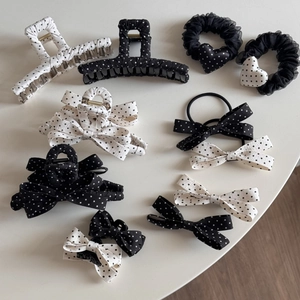 Collection of French vintage black and white polka dot hair clips and bows on table