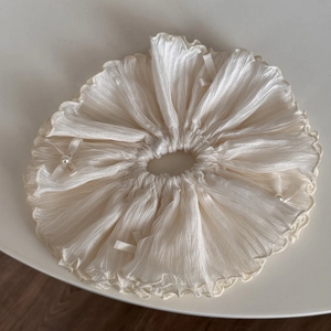 Detail of white chiffon scrunchie with layered pleats, pearl beads and ribbon bows
