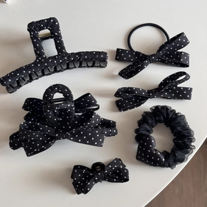 Detail view of French black and white polka dot hair claw set with bow and scrunchie