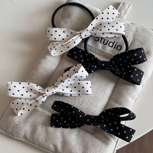 Detail of classic black and white polka dot bow hair accessories set in cotton canvas