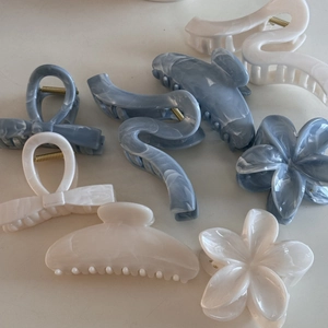 Detail shot of large acetate shark hair clips with blue and white marble textures