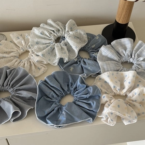 Detailed macro view showing diverse textures and patterns of oversized fabric scrunchies
