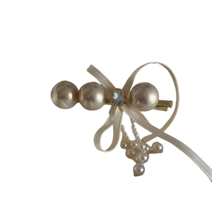 Elegant bow hair clip with pearls and long tassels in a minimalist Korean style