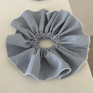 Detail of blue and white gingham oversized scrunchie with soft ruffled layers and stitching